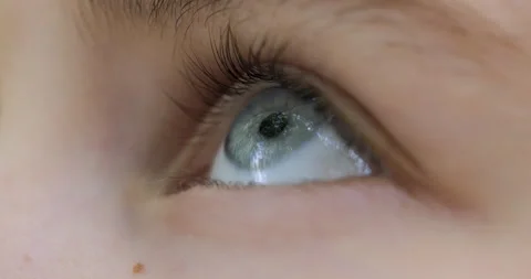 Blue Eye of Child Looking up Closeup. Person Looking Up at Sky in Outdoors... Stock Footage 340633538