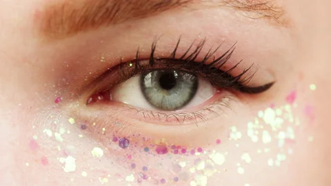 Blue eye close-up, glitter on low eyelid, painted lashes. Optical shop concept Stock Footage 171530471
