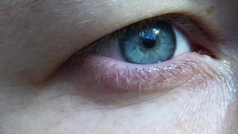 Blue Eye Close-Up with Light Reflection Stock Footage 265874223