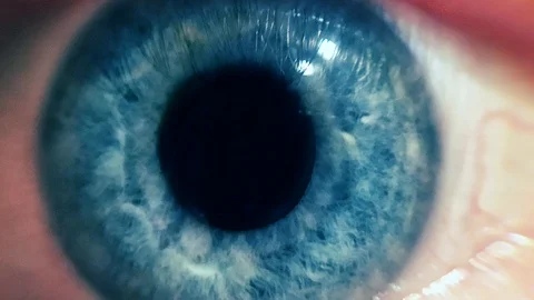 Blue eye pupil zoom in futuristic space burst Stock Footage