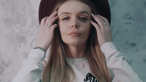 Blue-eyed blonde model with the hat is thinking about nice things. Close up Stock Footage 86658528