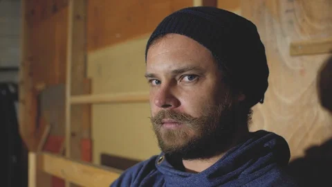 A blue-eyed man with a beard and mustache shouts to someone.stylish hipster Stock Footage 102941925