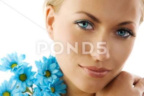 Blue eyes and blue daisy Stock Photos