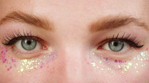 Blue eyes close-up, glitter on low eyelids, painted lashes. Optical shop concept Stock Footage 224907959