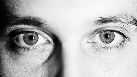 Blue eyes moving a boy on black and white Stock Footage 76768053