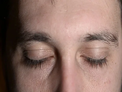 Blue eyes moving a boy in a dark room Stock Footage 76769780