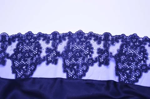 Blue fabric with an openwork pattern on a white background. An element of fin Stock Photos