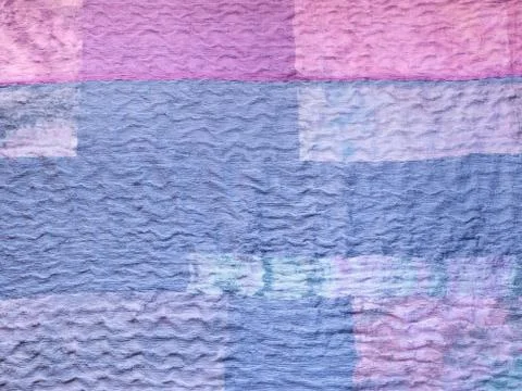 Blue fabric on patchwork cloth Stock Photos