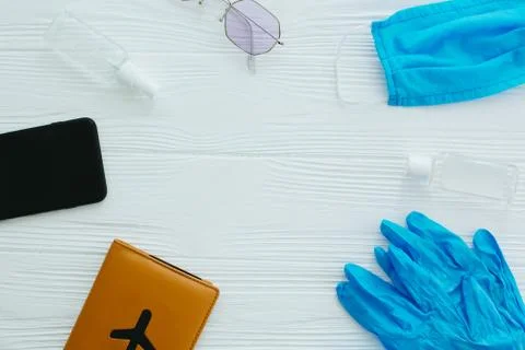 Blue face mask, gloves, antiseptic and disinfectant, passport, sunglasses and Stock Photos