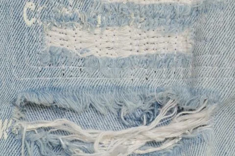 Blue faded ripped jeans, close up Stock Photos