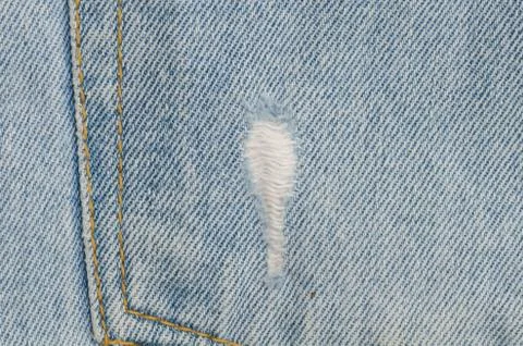 Blue faded ripped jeans, close up Stock Photos