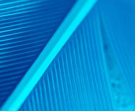 Blue feather as a background. Stock Photos