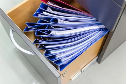 Blue file folder documents In a file cabinet retention of contracts. Stock Photos