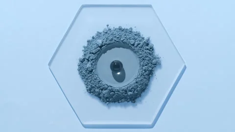 Blue fine powder with hydrogel sphere on hexagonal glass Stock Footage 337762802