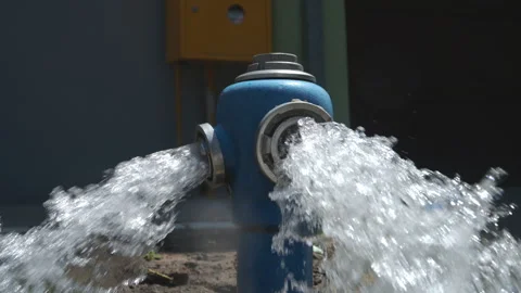 Blue fire hydrant releasing a powerful stream of water during system flushi.. Stock Footage 339652464