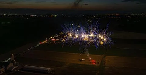 Blue Fireworks Exploding Low In The Night Sky, Creating Bright Bursts Over .. Foto stock