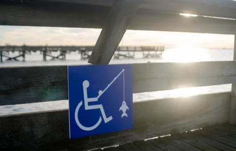 Blue fishing sign indicates wheelchair accessible on fishing pier at Jones Be Stock Photos
