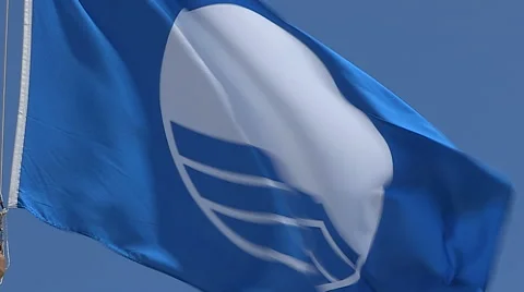 Blue flag flying at beach indicating clean water Stock Footage 58517681