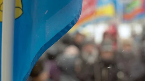 Blue flag over blurred crowd Stock Footage 127691969