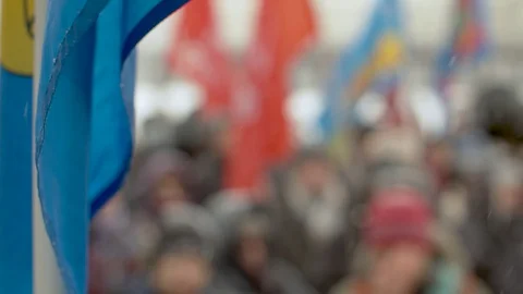 Blue flag over blurred crowd Stock Footage 127692330