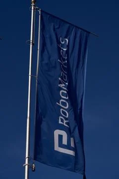 Blue flag of RoboMarkets flagpole Stock Photos