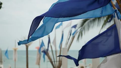 Blue flags waving in wind. Small triangular blue flags fluttering in wind in  Stock Photos