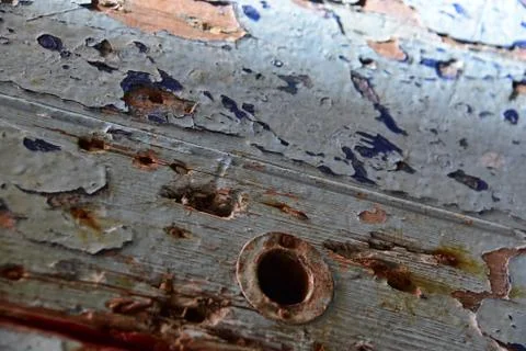 Blue Flaking paint on a door missing its handle Stock Photos