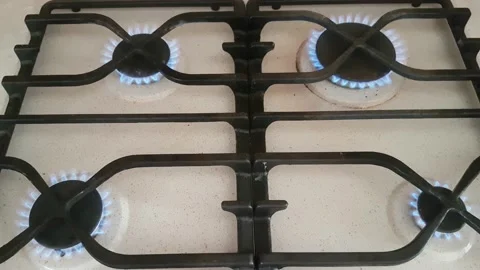 Blue flame burning on four burners of a kitchen gas stove Stock Footage 182556012