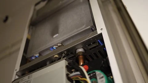 Blue flame ignites inside a gas boiler as the home heating system starts Stock Footage 344055456