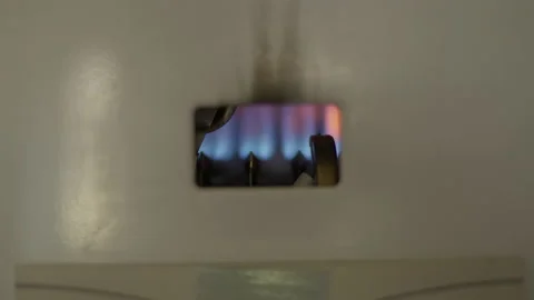 Blue flame igniting as gas water heater turns on. Close-up blaze of natural Stock Footage 179399166