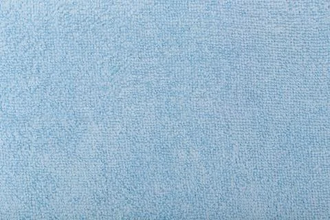 Blue fleecy fabric background. Top view of bright blue fiber. Stock Photos