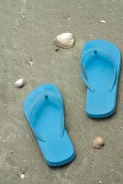 Blue flip flops on beach Stock Photos