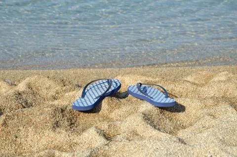 Blue Flip Flops on Beach Stock Photos