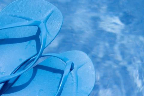 Blue flip flops on pool Stock Photos