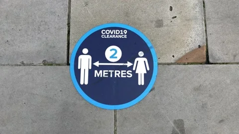 A blue floor pavement social distancing sticker label. London UK. Stock Footage 142326601