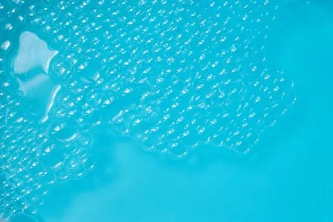 Blue Foam Surface. Clear bubbles floating on a bright turquoise surface Stock Photos