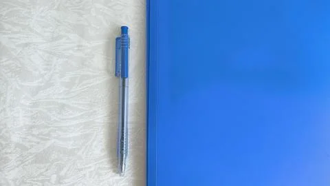 A blue folder and a pen on the table. The concept of paperwork, contract sign Foto stock