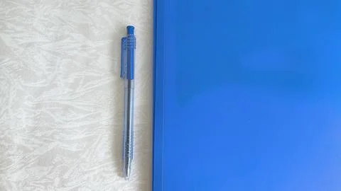 A blue folder and a pen on the table. The concept of paperwork, contract sign Foto stock