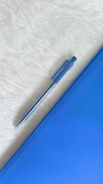 A blue folder and a pen on the table. The concept of paperwork, contract sign Foto stock