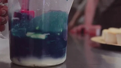 Blue food coloring mixing with whipped c... | Stock Video | Pond5