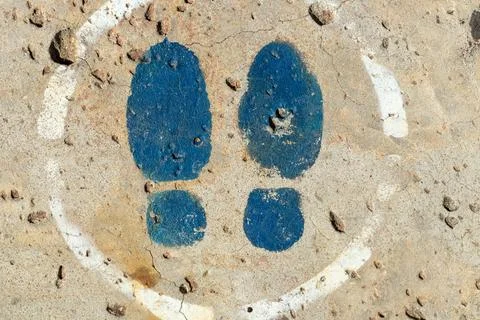 Blue Footprints Inside White Circle on Concrete Stock Photos