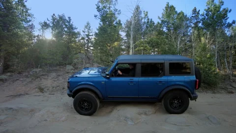 Blue Ford Bronco - passes Right to Left over off-road obstacles Stock Footage 170901633