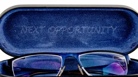 Blue framed reading glasses sit in an open blue velvet lined case, showcasing Stock Footage 332537195