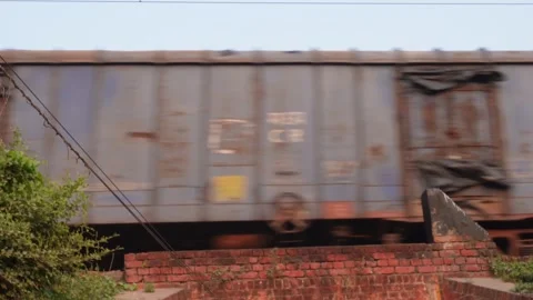 Blue Freight Train Blurring Past Red Brick Wall Stock Footage 326147906