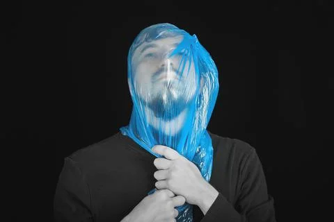Blue garbage bag on man head. Exit bag for suicide. Stock Photos