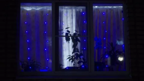 A blue garland is burning in the window Stock Footage 159881906