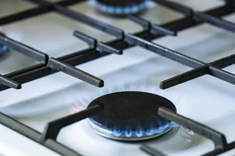 Blue Gas Flame Burning on Kitchen Stove Burner Close Up Stock Photos