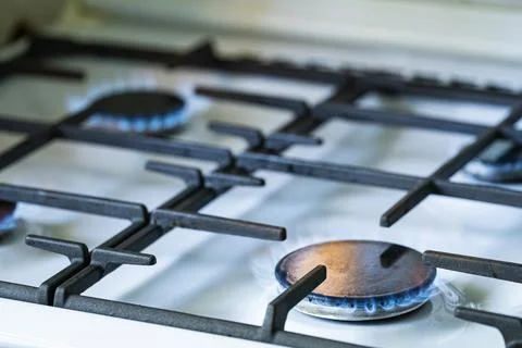 Blue Gas Flame Burning on Kitchen Stove Burner Close Up Stock Photos