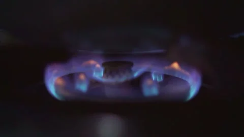 Blue gas flame burning steadily on a stove burner, energy source for cooking in Stock Footage 333169700
