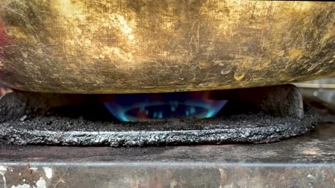 Blue Gas Flame Burning Under Brass Cauldron on Traditional Stove Stock-Footage 336796748